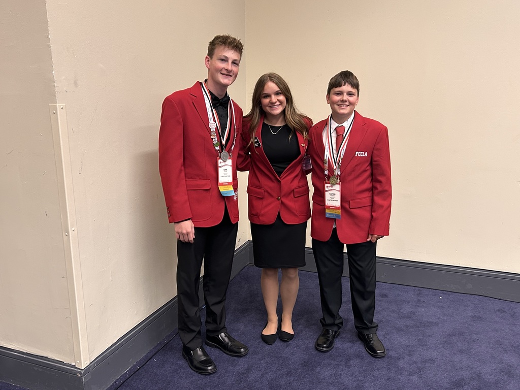 Salisbury students Lydea Britt, Lane Cruse, and Easton Cooper pose for a photo in official dress at FCCLA National Conference in Washington DC.