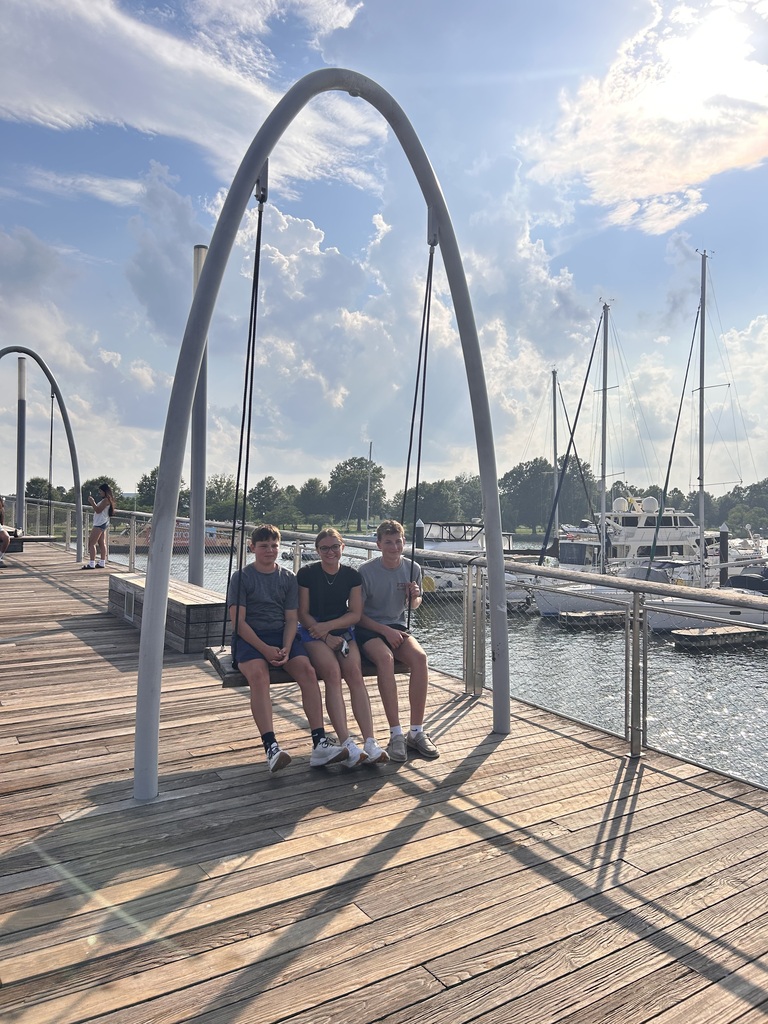 Lydea Britt, Lane Cruse, and Easton Cooper swing on the boardwalk at FCCLA National Leadership Conference.