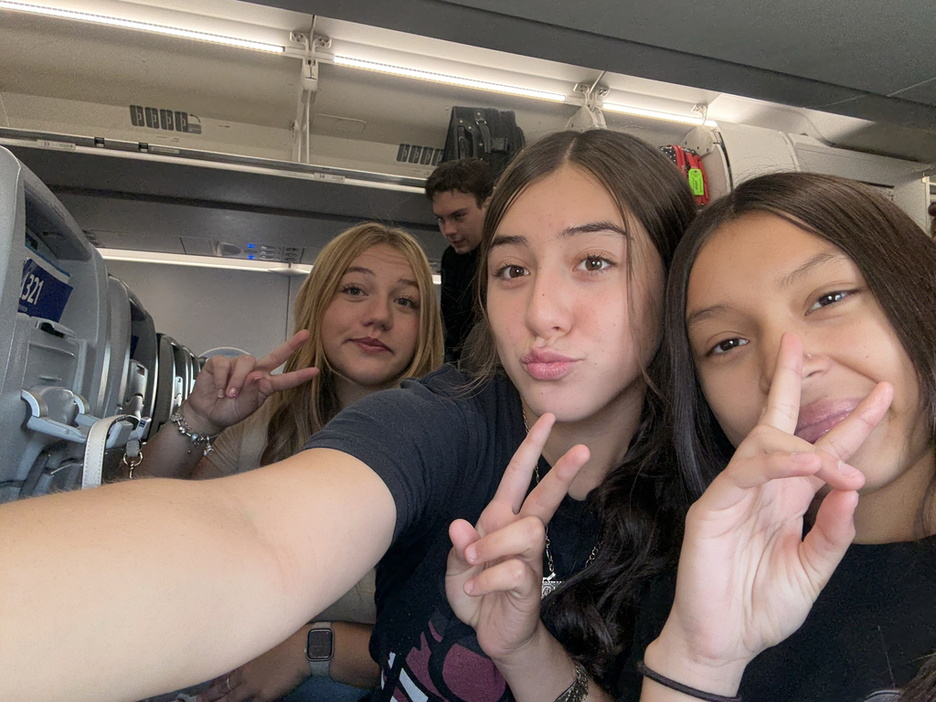 3 girls on an airplane.