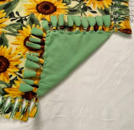 green and sunflower tied felt blanket