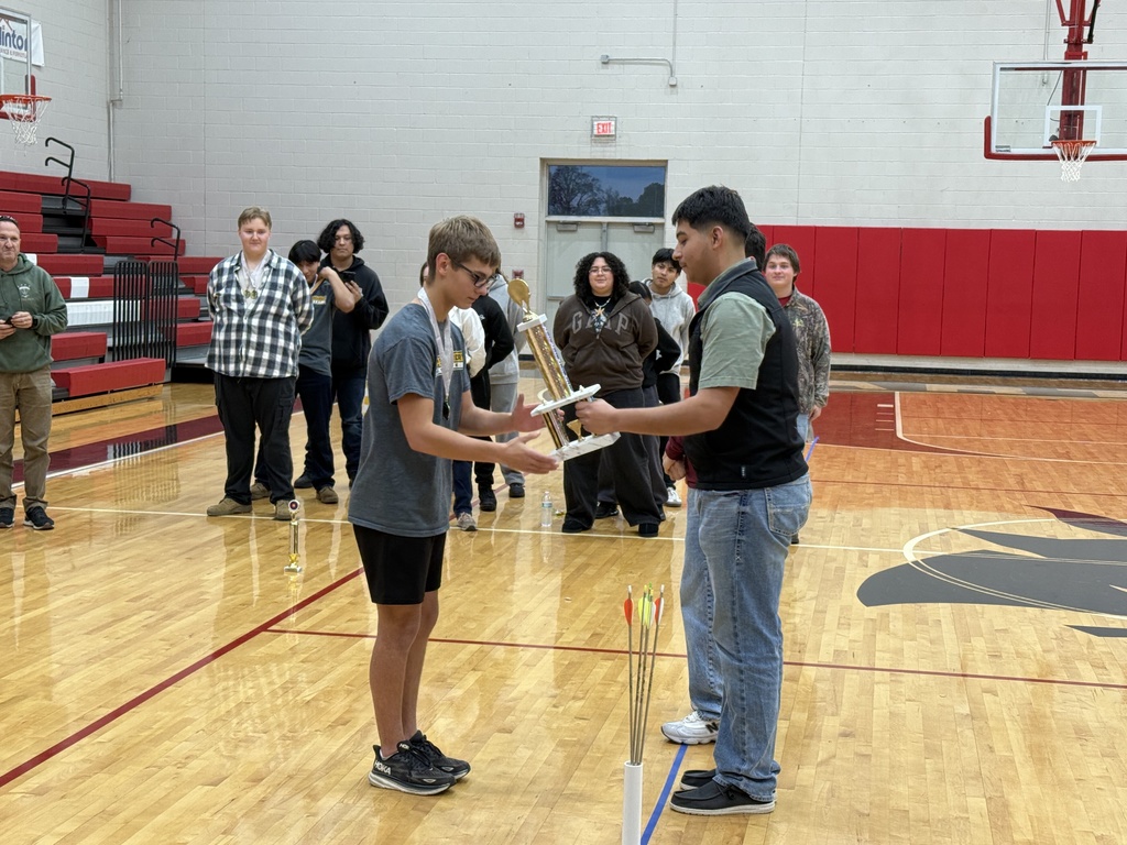 Elijah receives trophy.