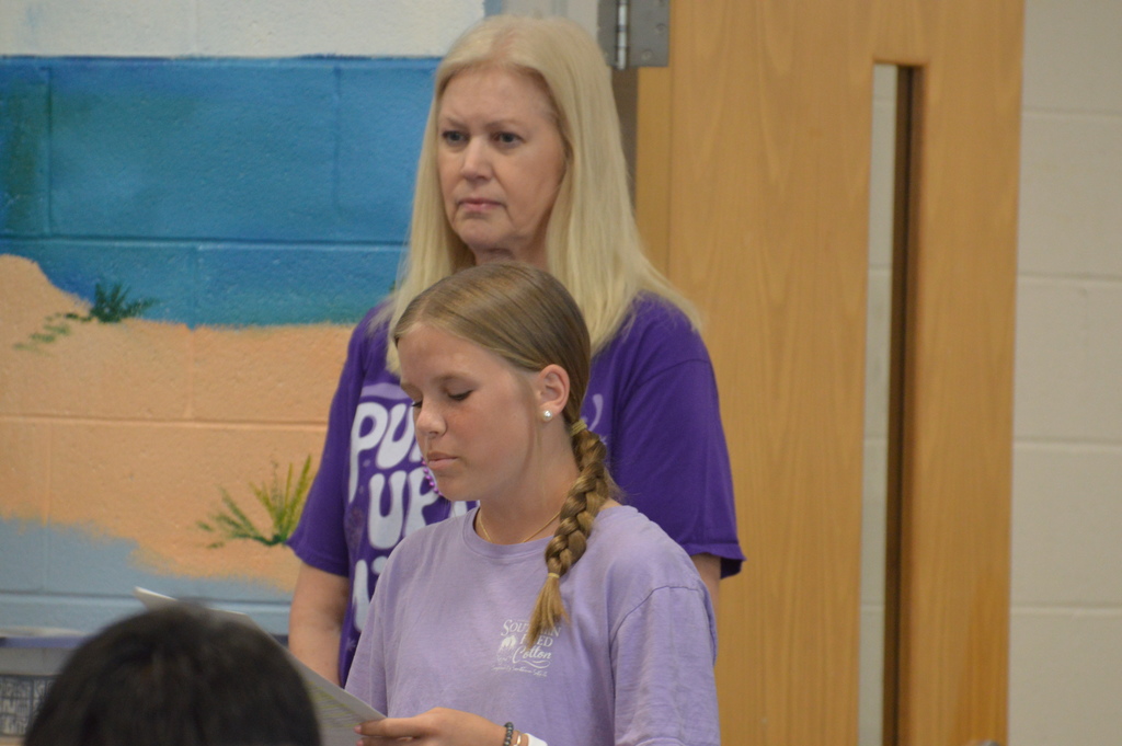 Emery Williams, FBLA President, reading a poem for Purple Up day.