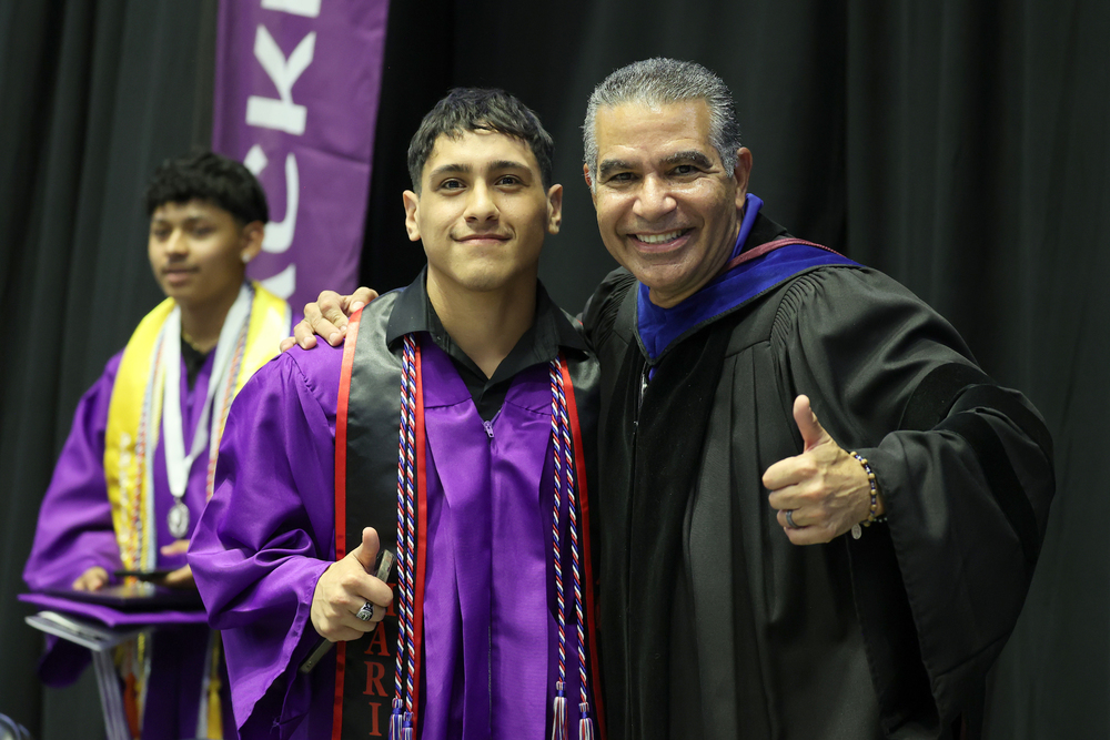 Male grad with superintendent