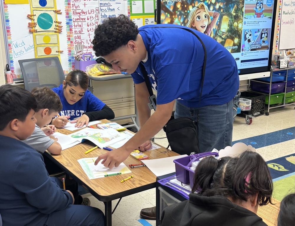 male and female high school student assist younger studetns