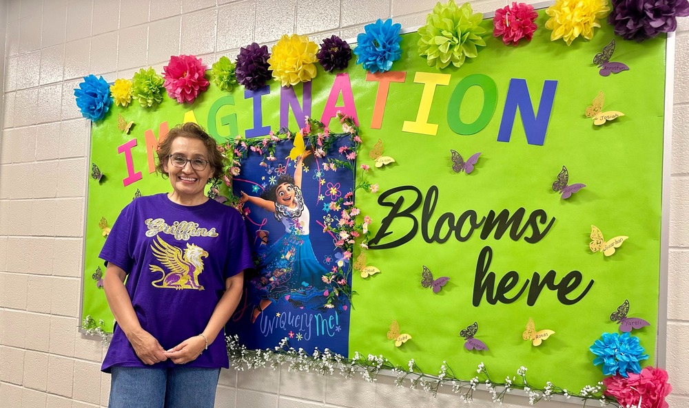 Ms. Williams in front of Imagination Blooms Here