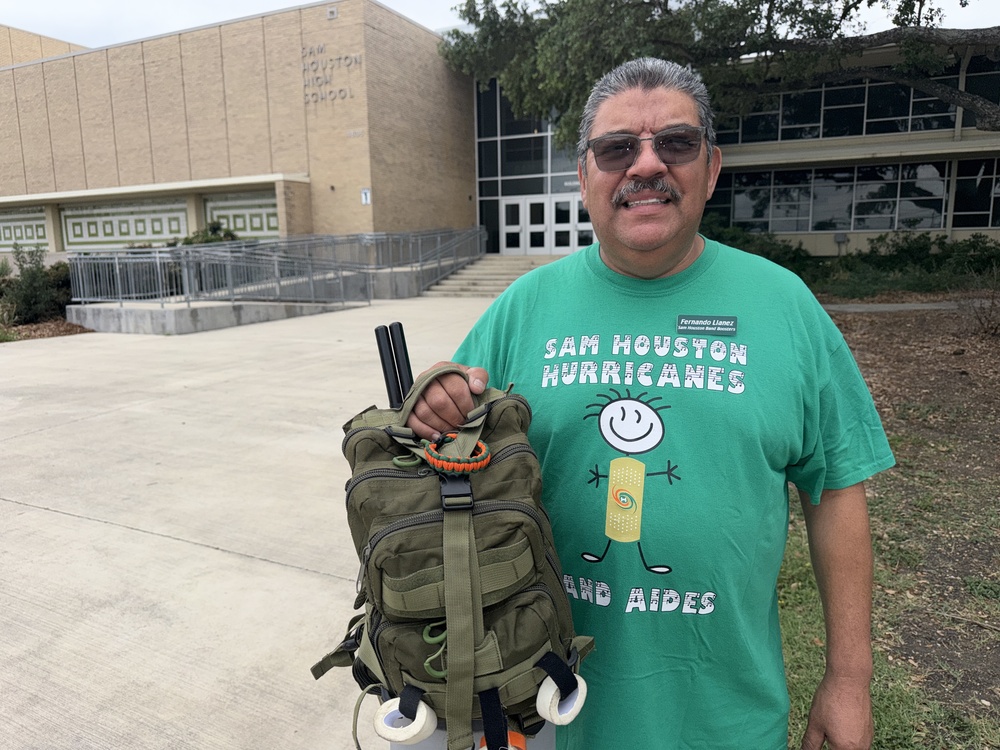 Man holding backpack with supplies