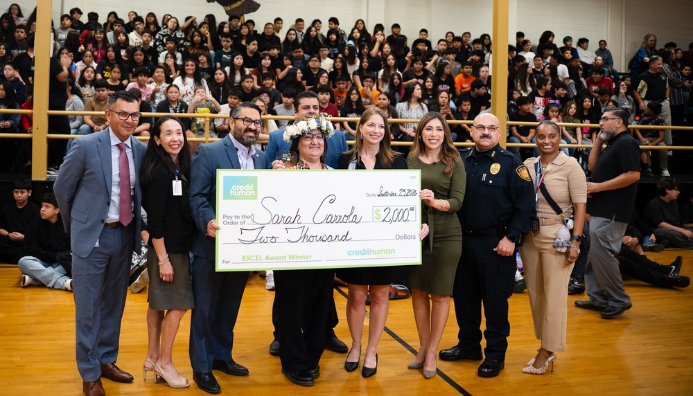 Group of people with large check presentation