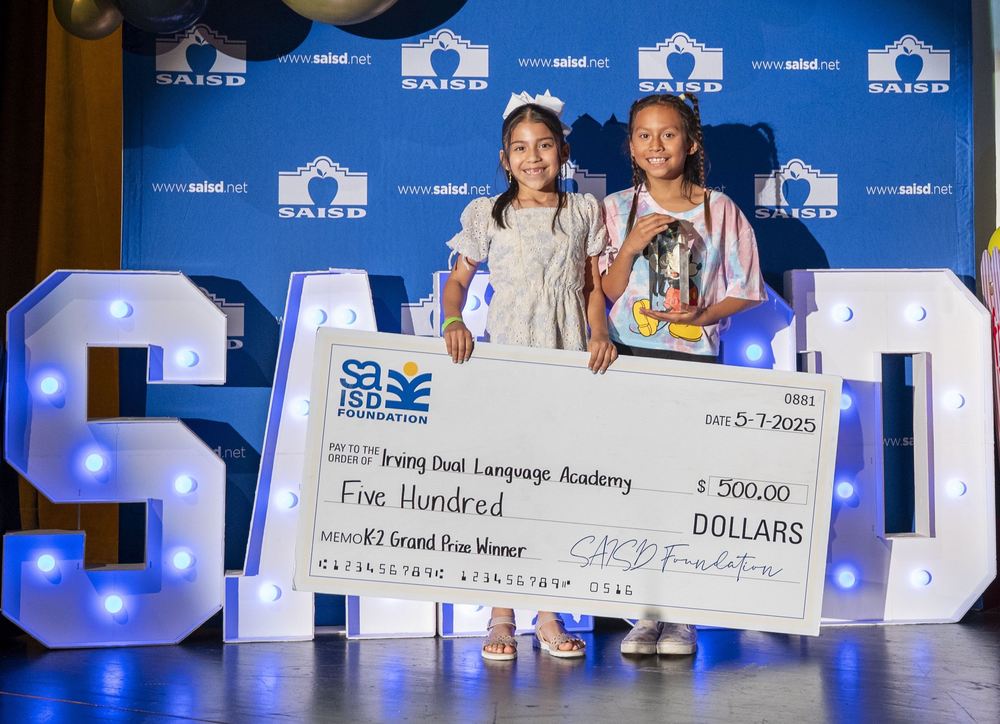 Two girls hold big check