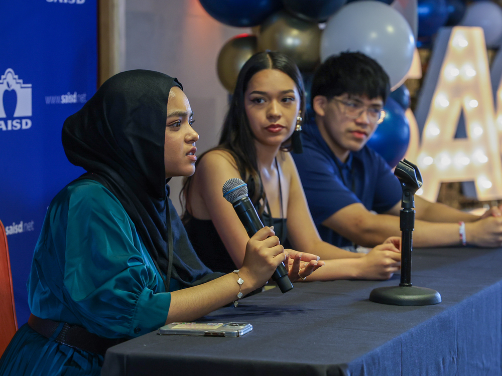 Three-student panel with microphone