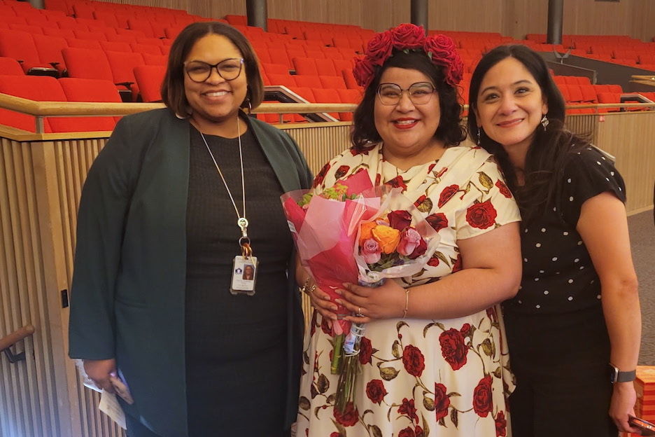 Three women in auditorium