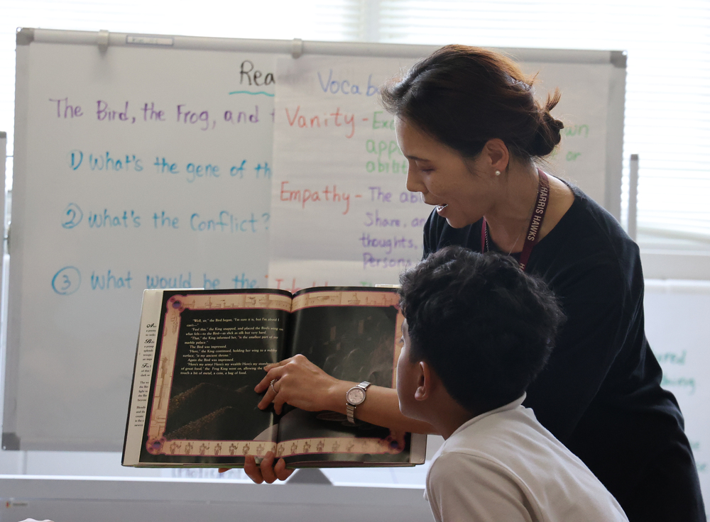 Teacher reads with student
