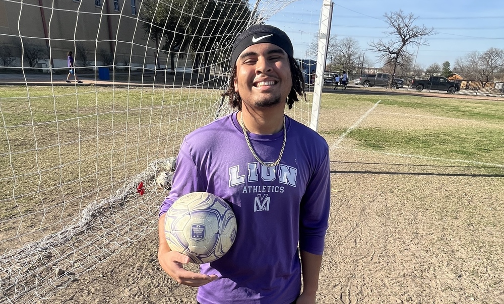 Student holding soccer ball