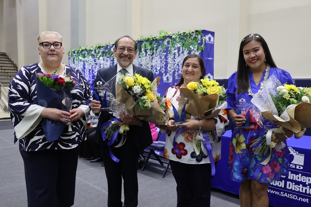 Four adults holding bouquets