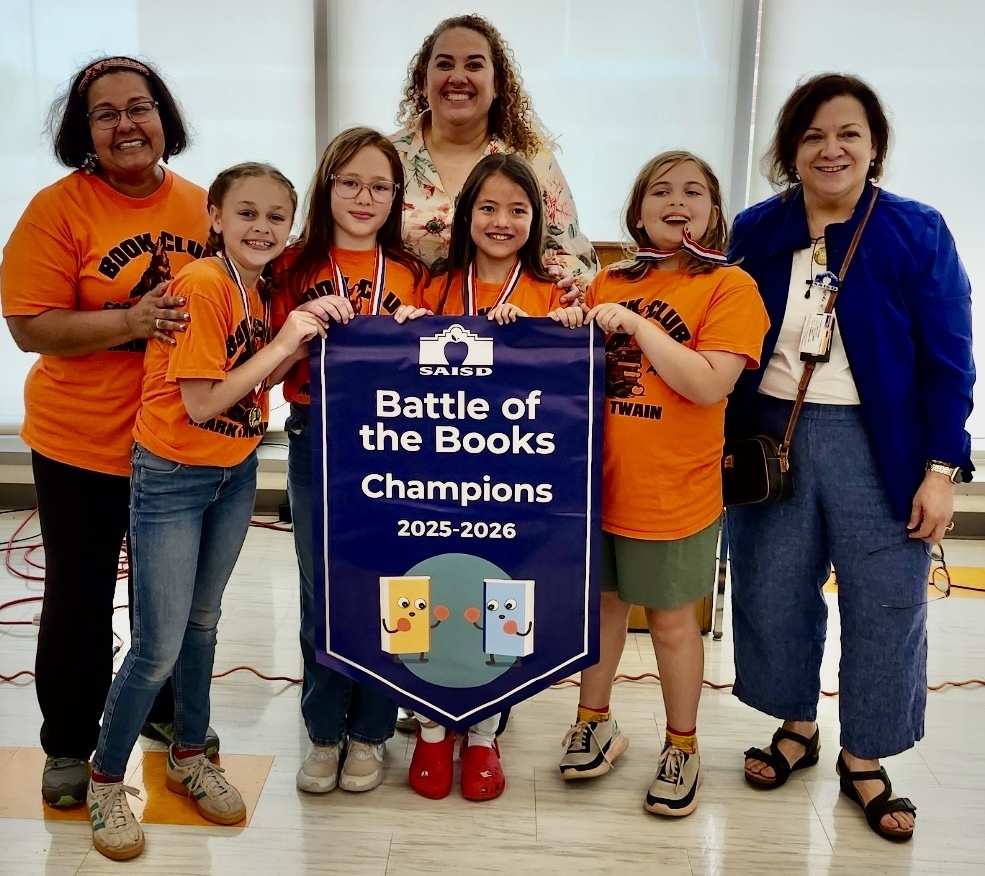 Students hold Battle of The Books Champions banner