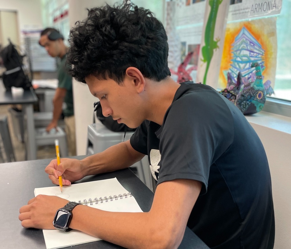 Student drawing in art class