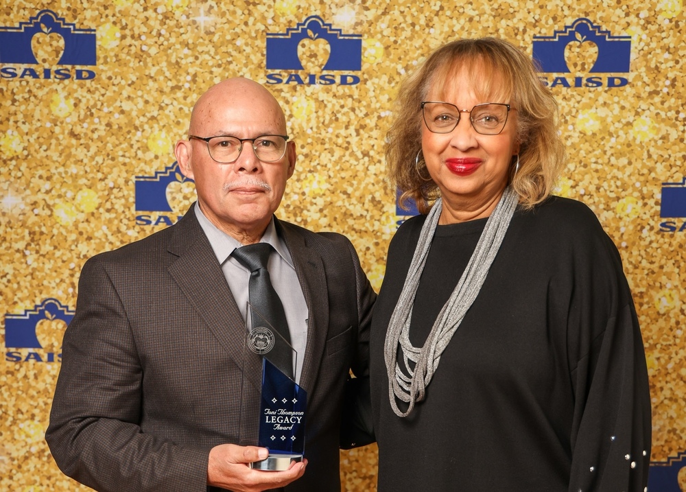 Man with trophy and woman