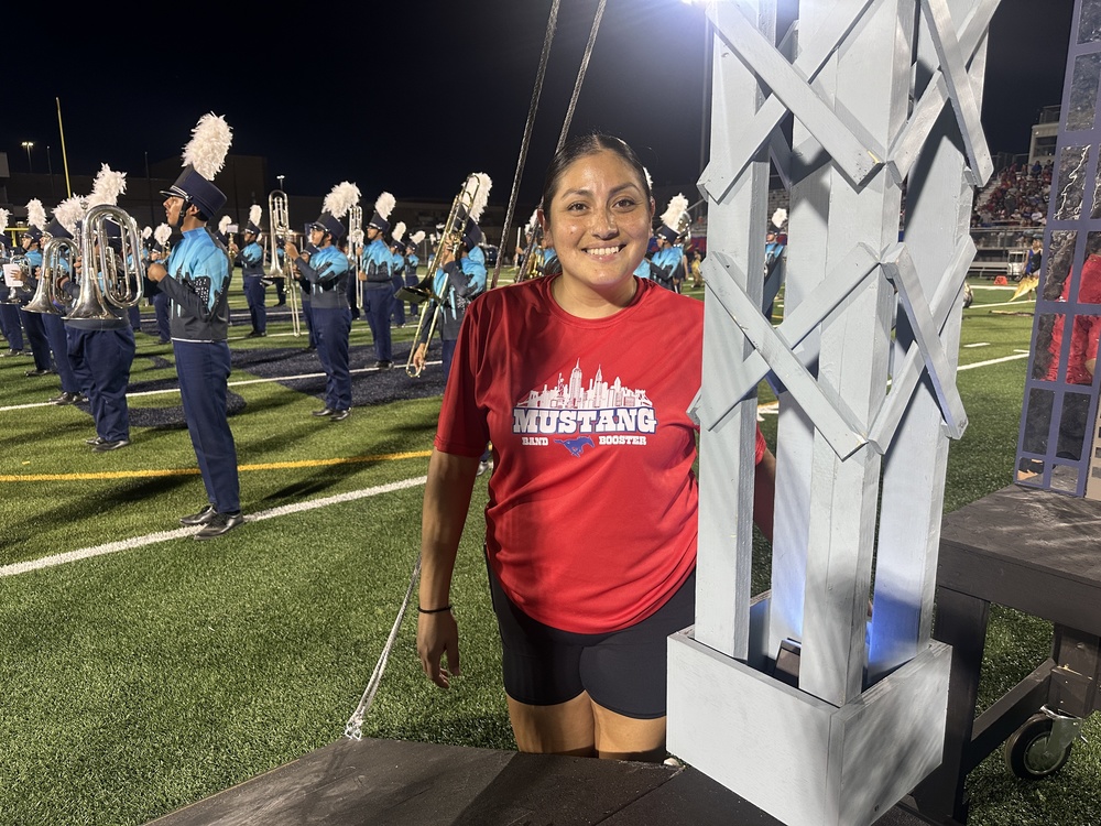 Woman stands with band bridge prop