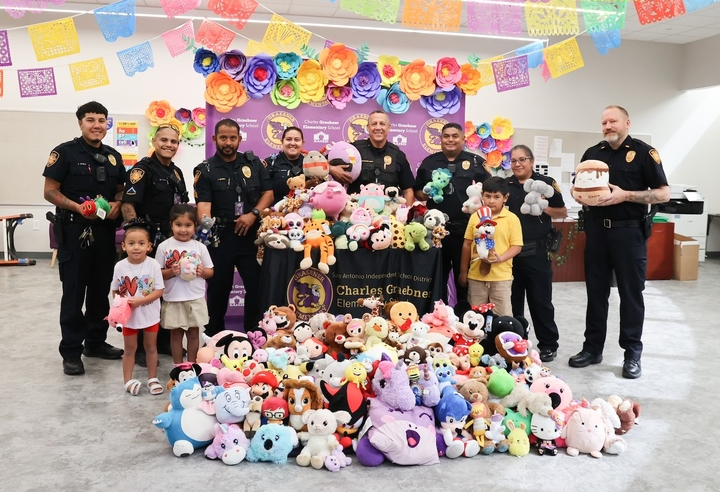 Students stand with police and stuffed animals