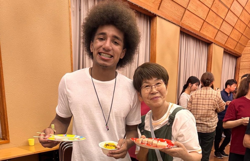 Student with plate of food in Japan
