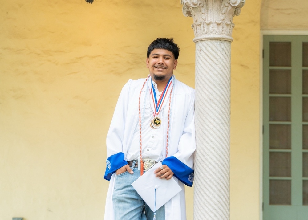 male student in white graduation robe