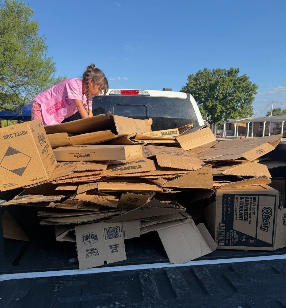 Girl with mountain of cardboard