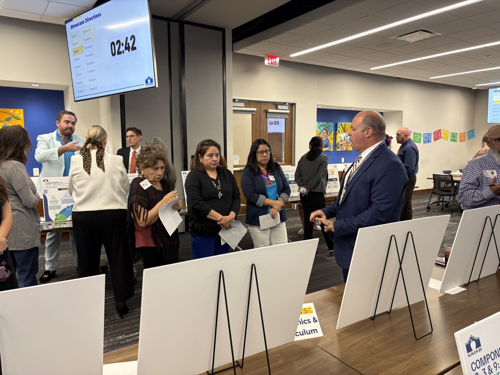 People viewing posters and hearing presentations