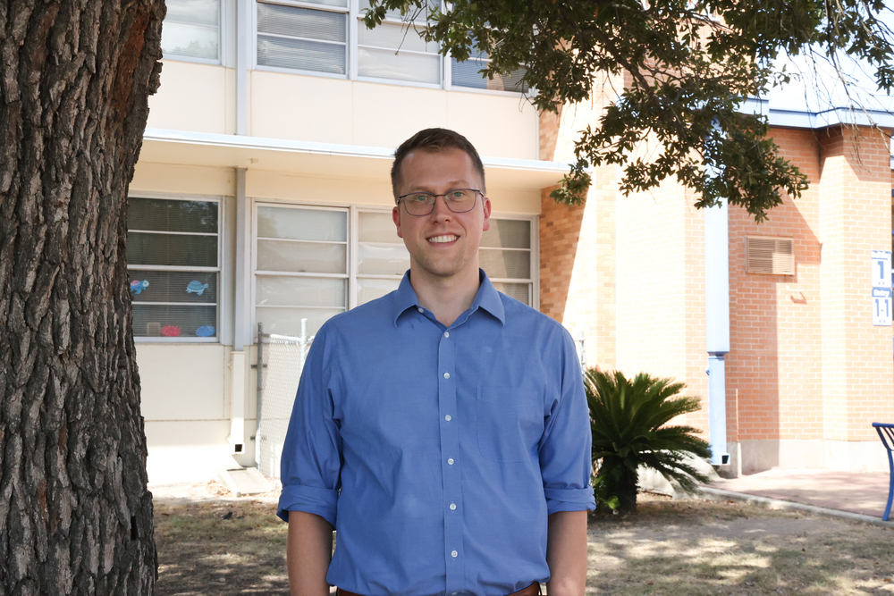 Man standing in front of school