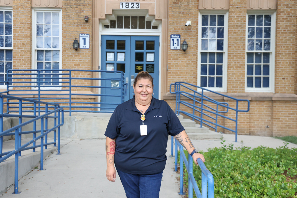 Woman stands in front of building