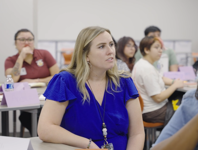 teacher listening to a speaker