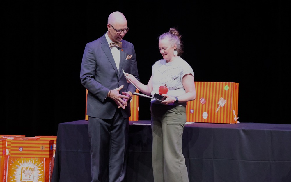 Man gives certificate to teacher