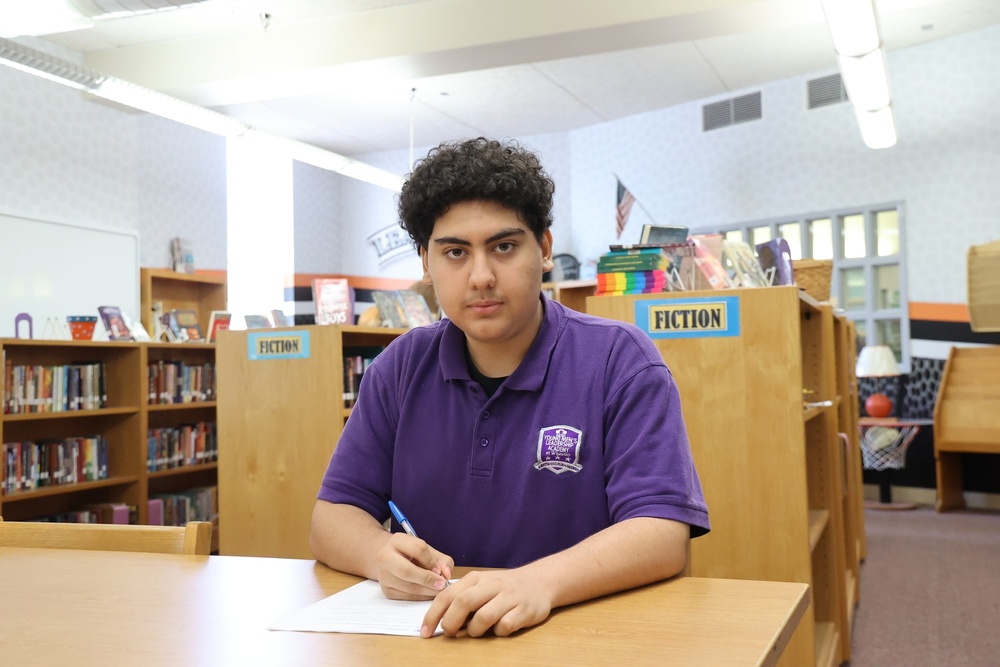 Male student signing a document