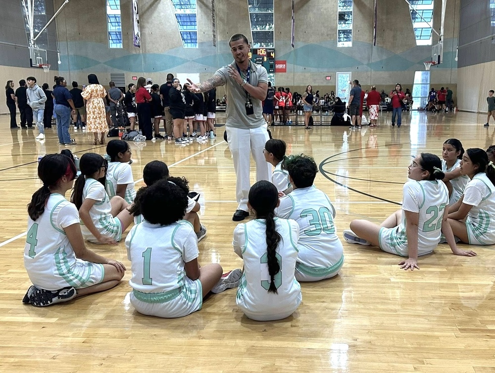 Coach talking to girls basketball team