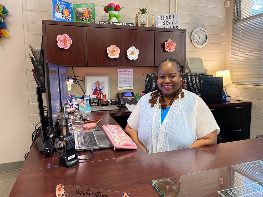 Principal Williams sits at desk