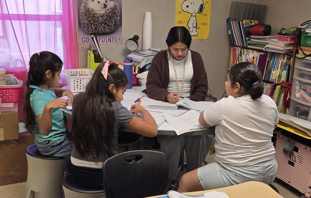 Emerging educator with small group reading