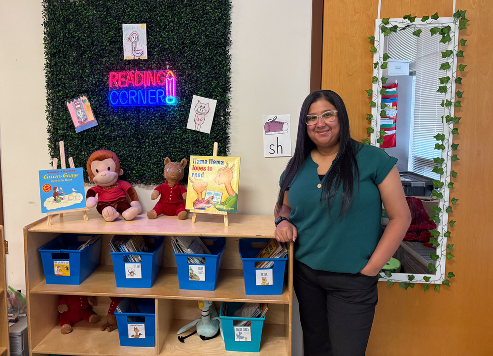 Woman stands by Reading Corner