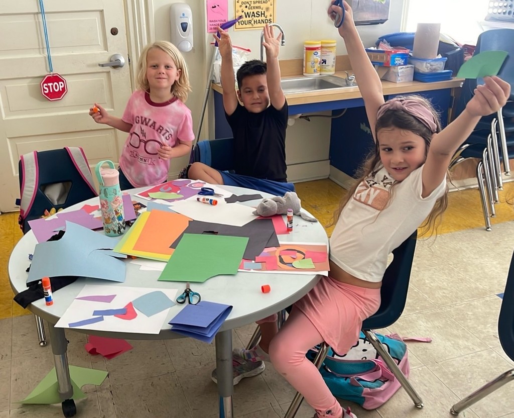 Students engaged in learning and art at summer learning