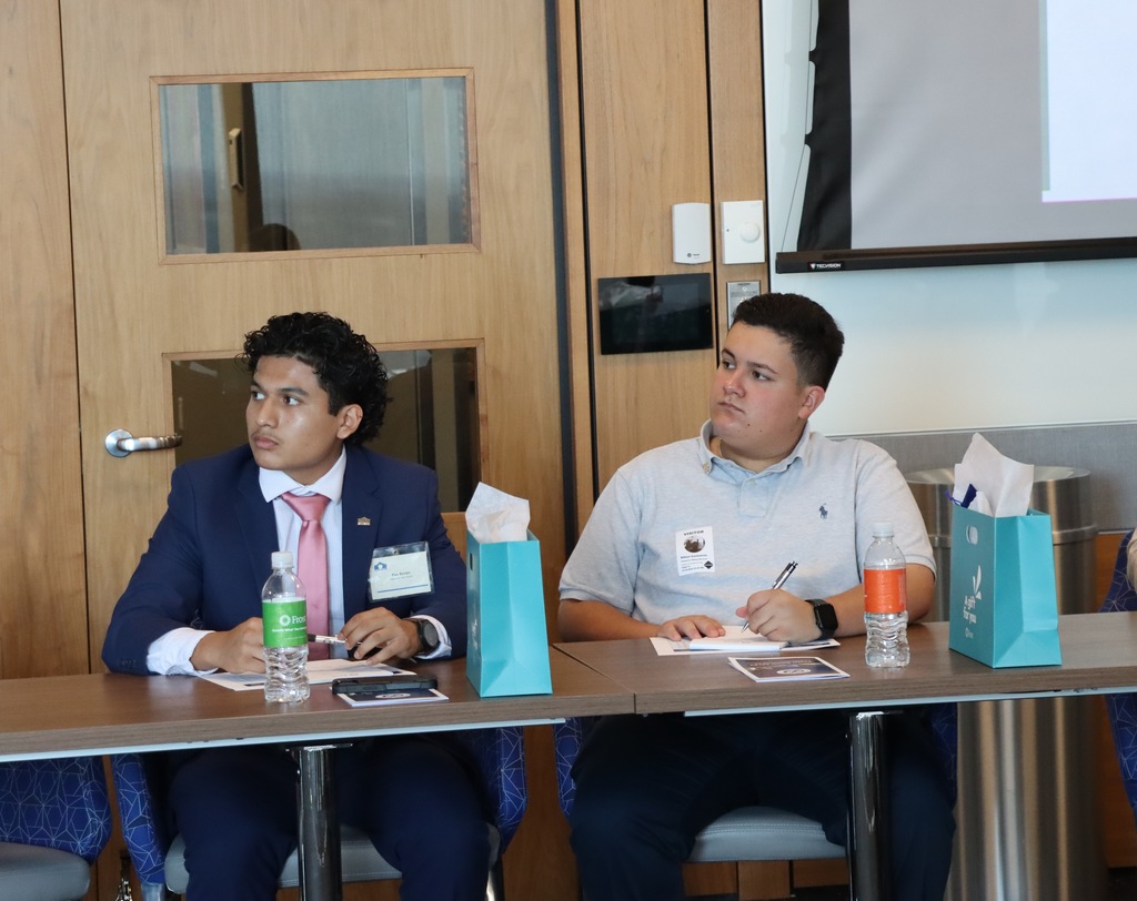 Two students listen to presentation