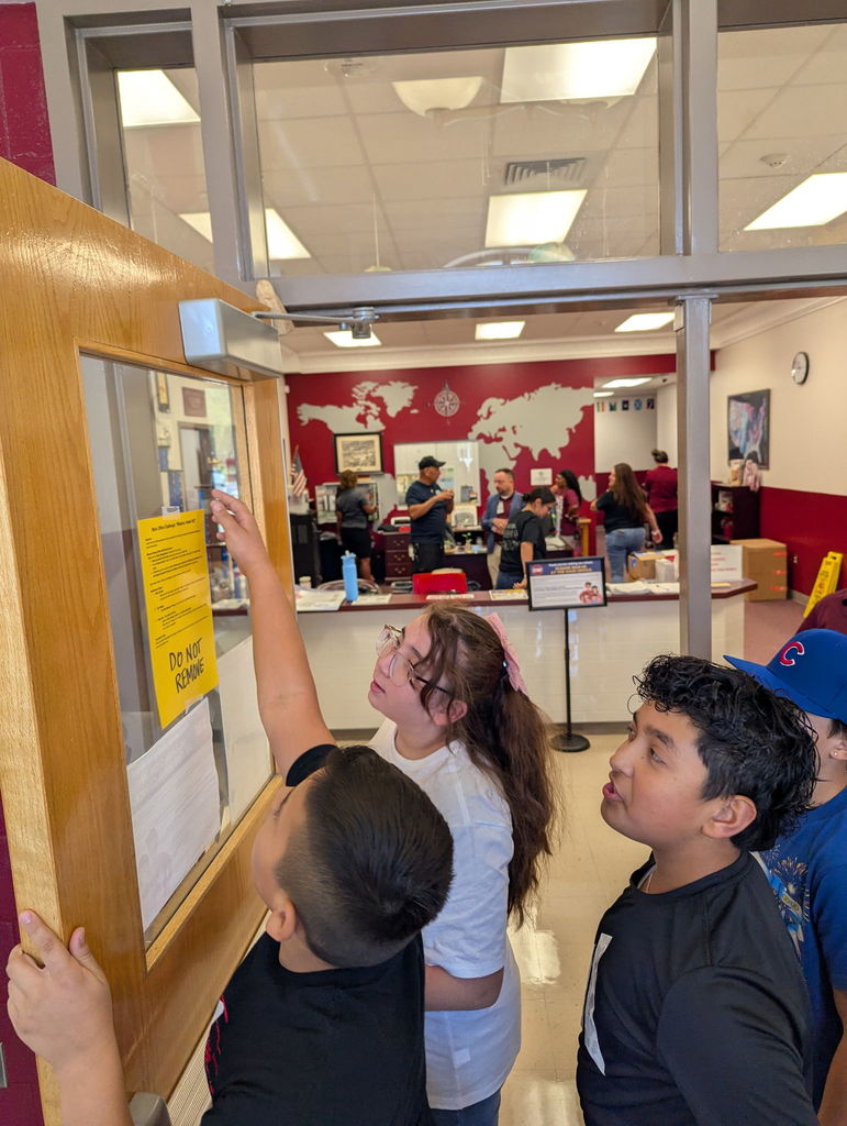 kids reading a challenge that is posted on the door