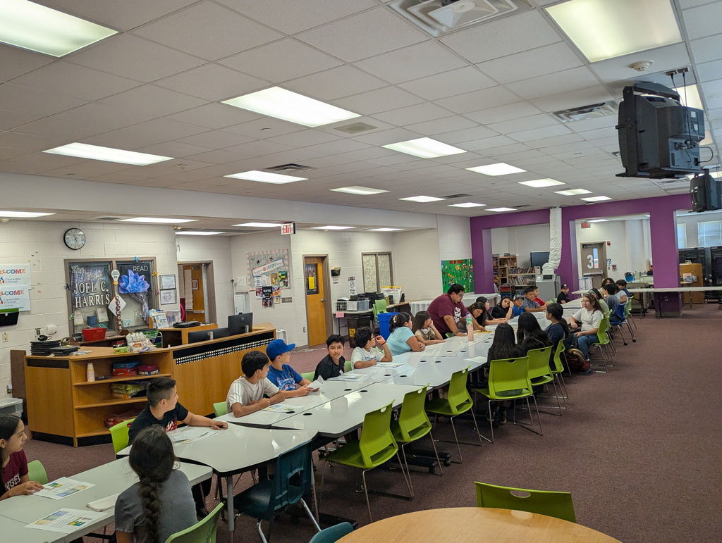 students sitting at the table in the library