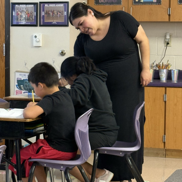 Ms. Garcia assists two students as they complete the problem.
