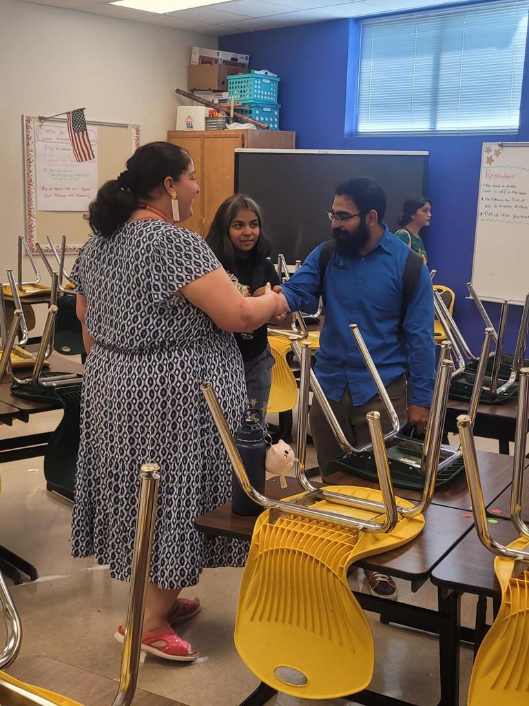 Teacher shaking hands with family