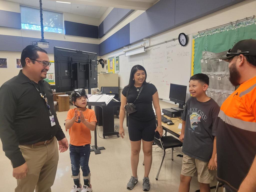 Family with Mariachi teacher, child with orange t-shirt