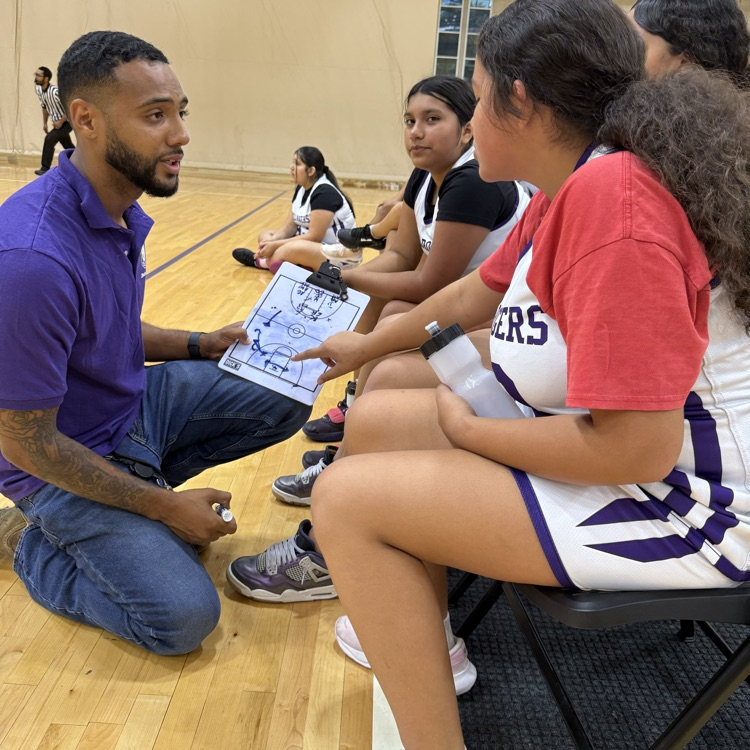 Coach discussing plays with players