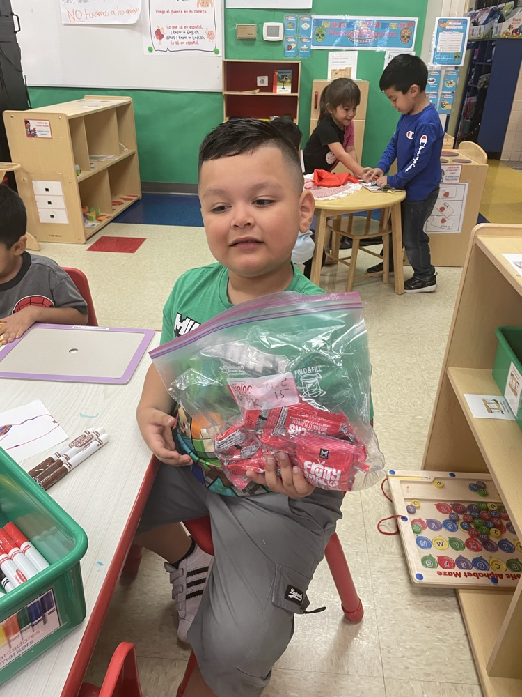 a student holding a bag of fruit snacks