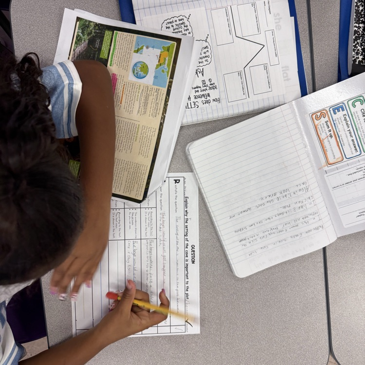 A student writes a response using a graphic organizer. 