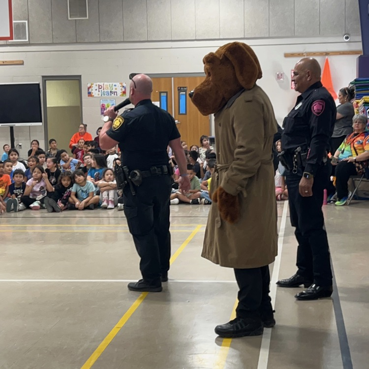 McGruff waits as officers talk to students.