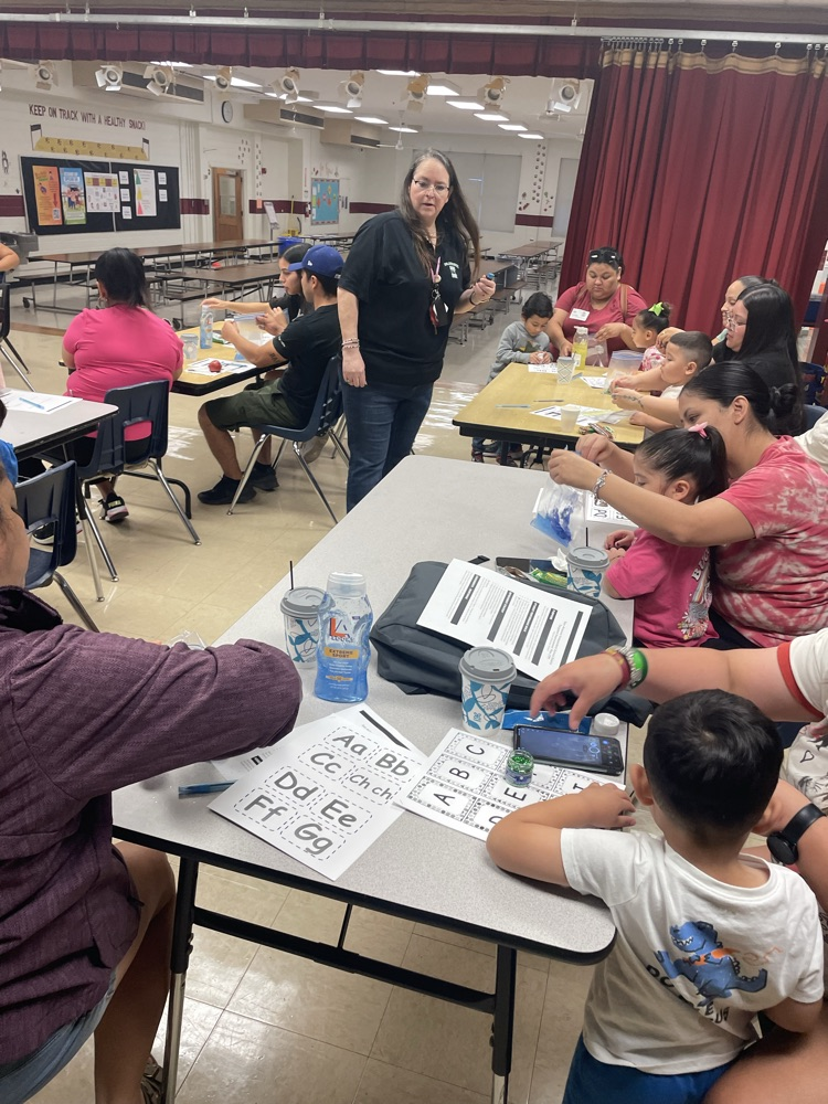 group of students and parents working on a letter activity