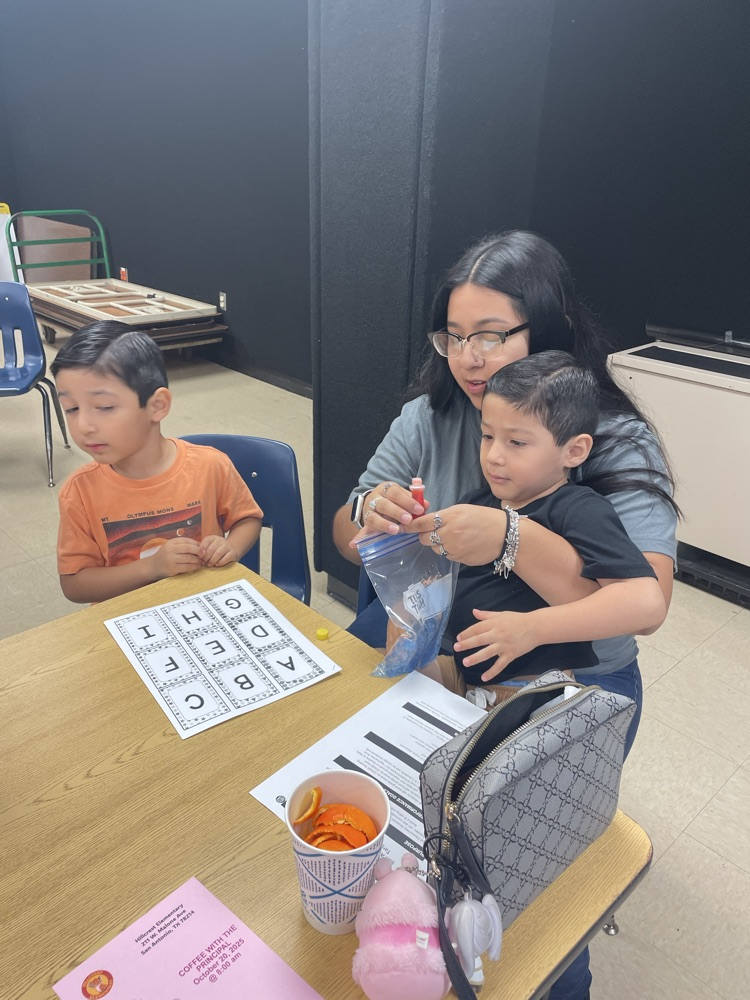 group of students and parents working on a letter activity