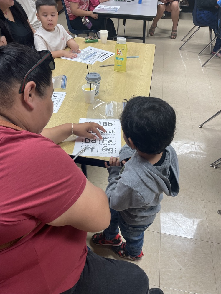 group of students and parents working on a letter activity