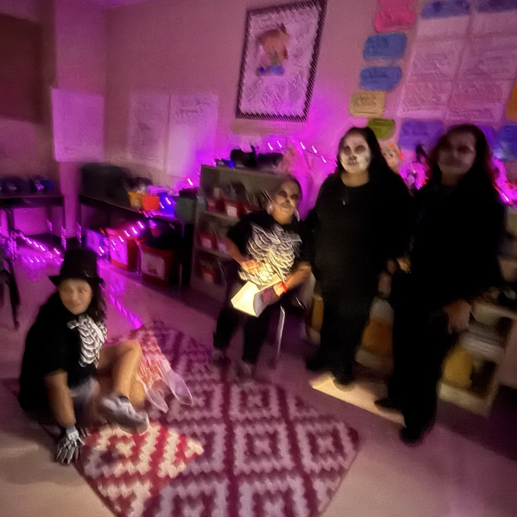5th grade teachers read a spooky tale to guests.